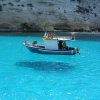 This picture is taken on One House Bay in Greece. The water is so clear that the boat seems to b.jpg