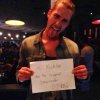 Drew Holding Up Sign to Fan.jpg