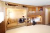 409747-Built_in_bunk_beds_become_part_of_an_open_communal_space_defined_by_a_curving_wall_of_wal.jpg
